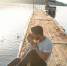 man and girl sitting on brown dock near boat and two white ducks during daytime - Администрация г.Лысьва